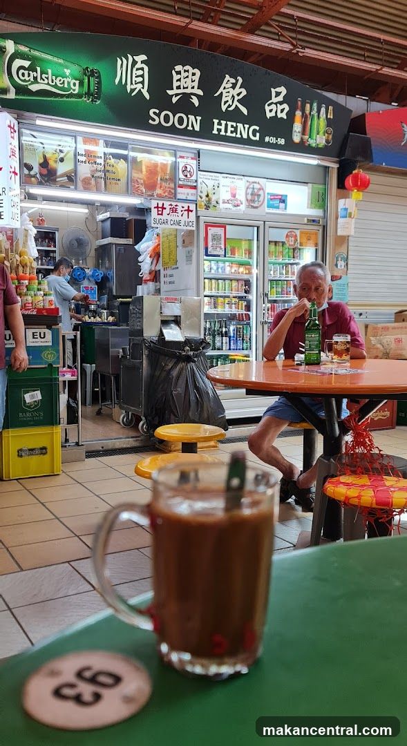 Man drinking beer at a food stall