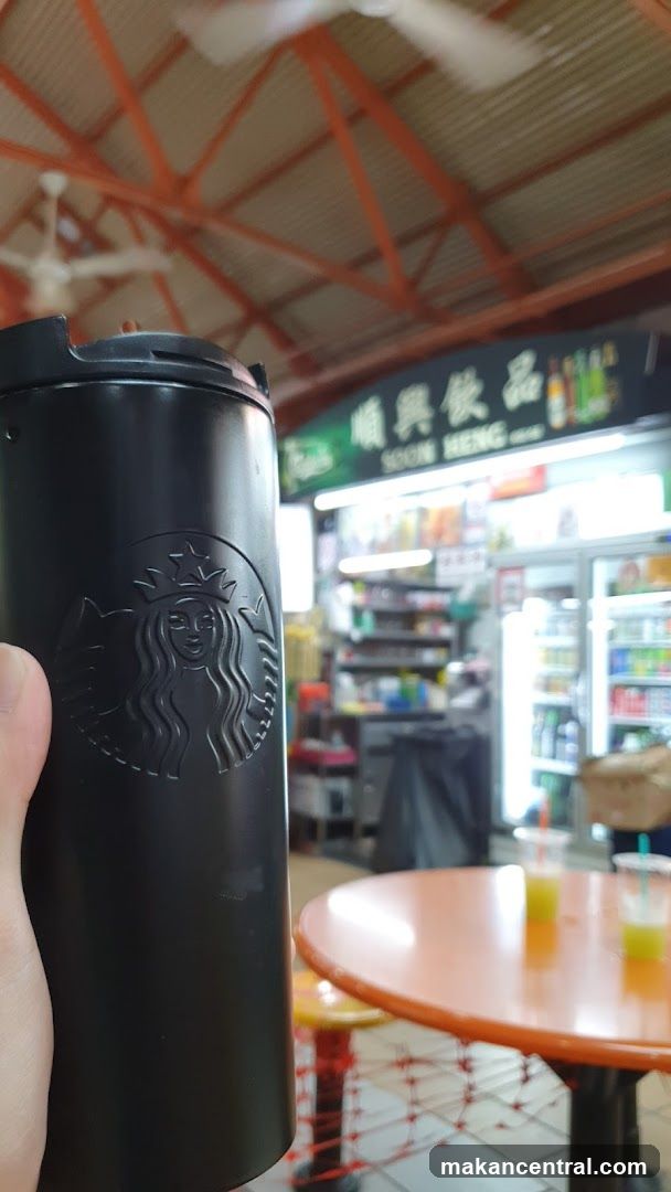 Starbucks Tumbler in front of a convenience store