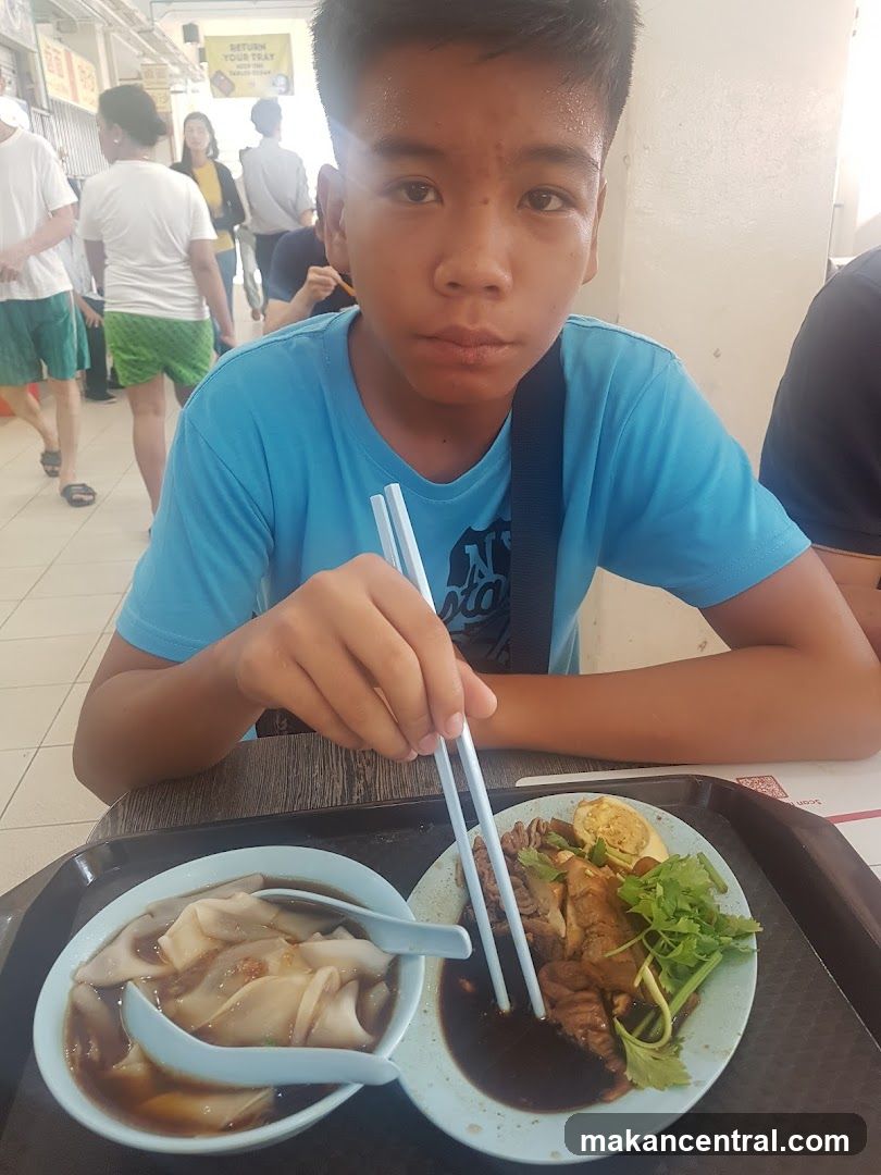 Boy eating at a food stall