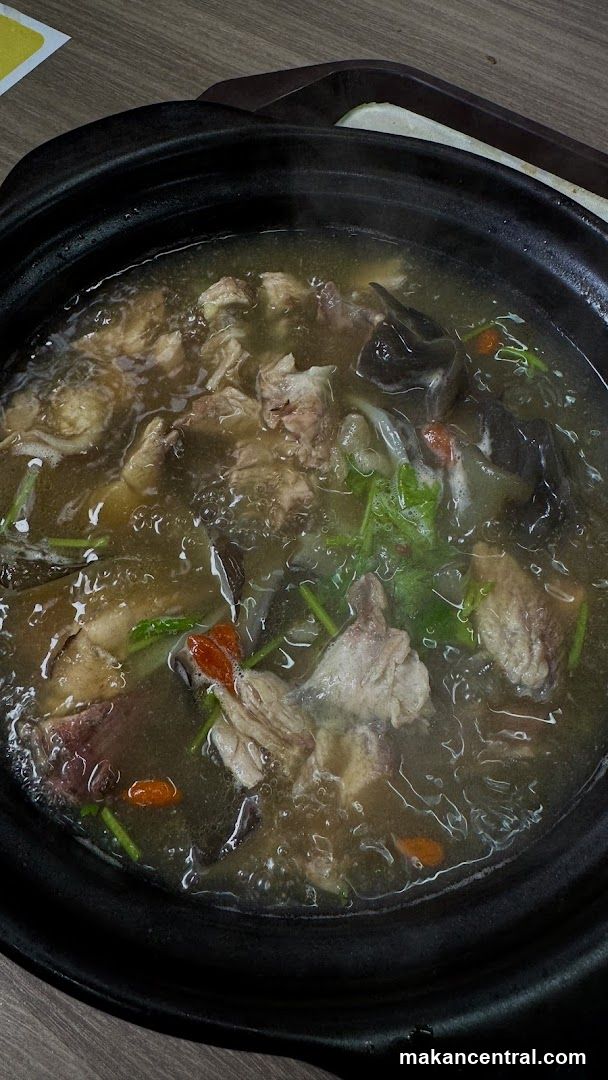 Steaming Hot Pot of Stewed Meat and Herbs