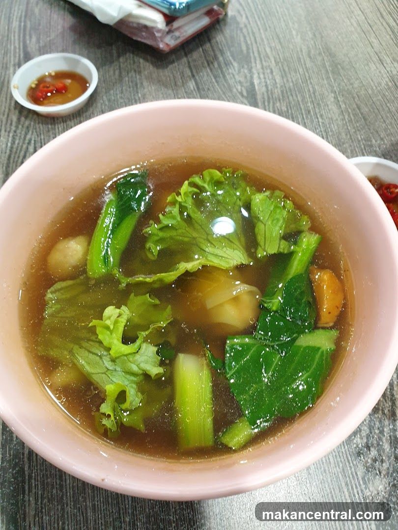Bowl of Soup with Vegetables and Meatballs