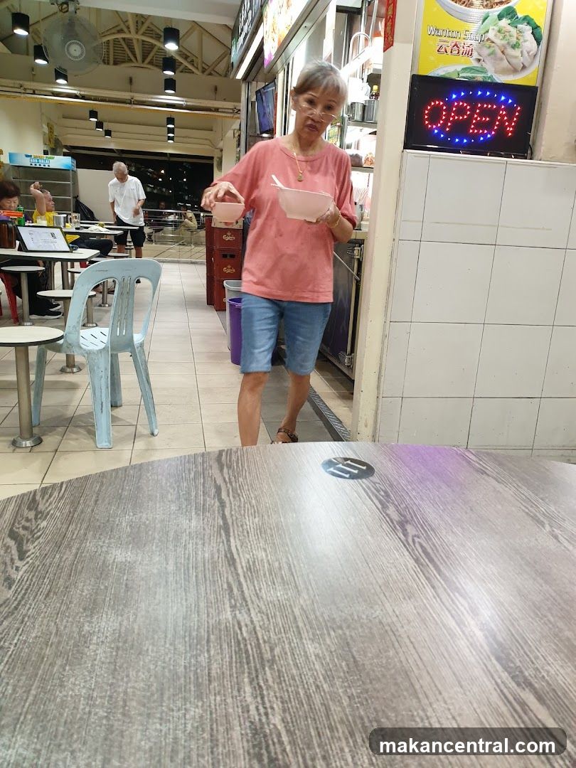 Woman holding bowls at food stall