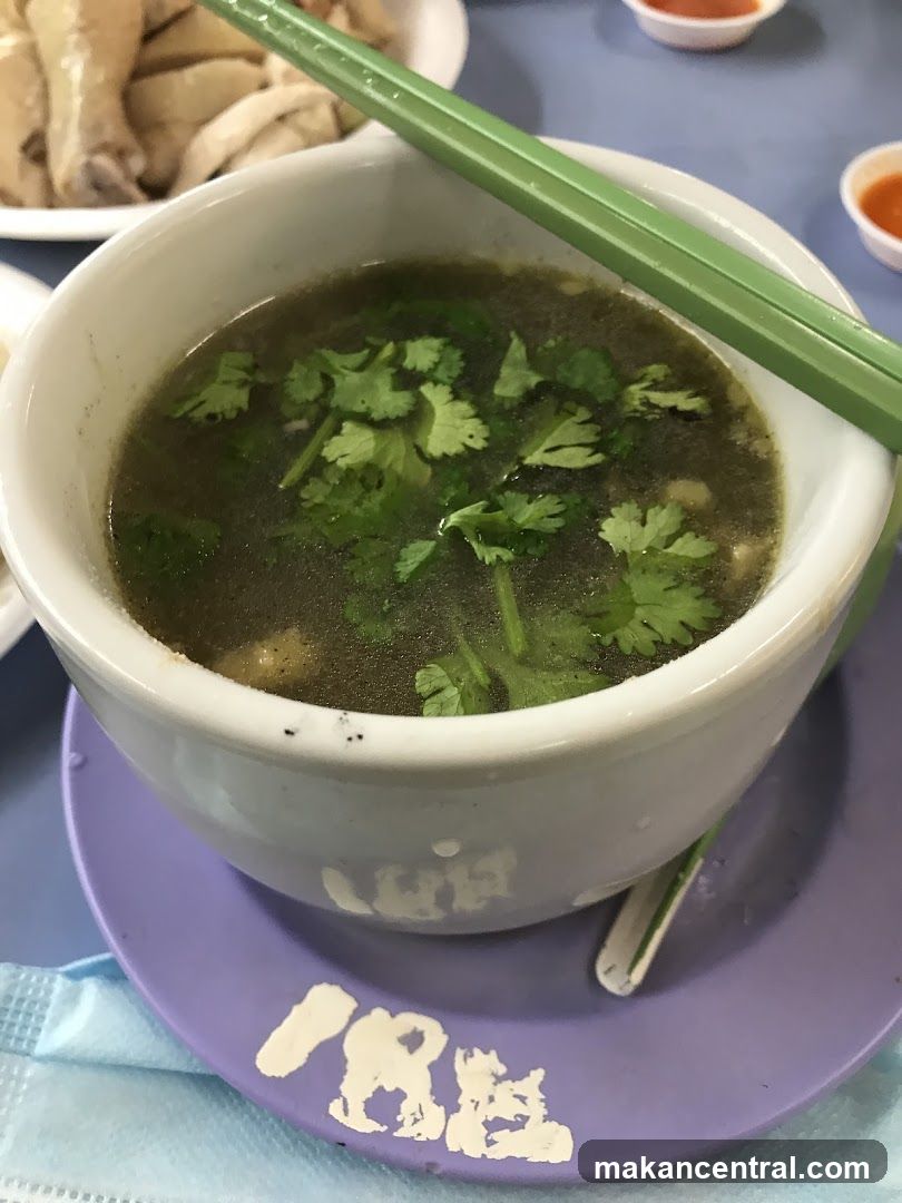 Bowl of soup with cilantro and chopsticks