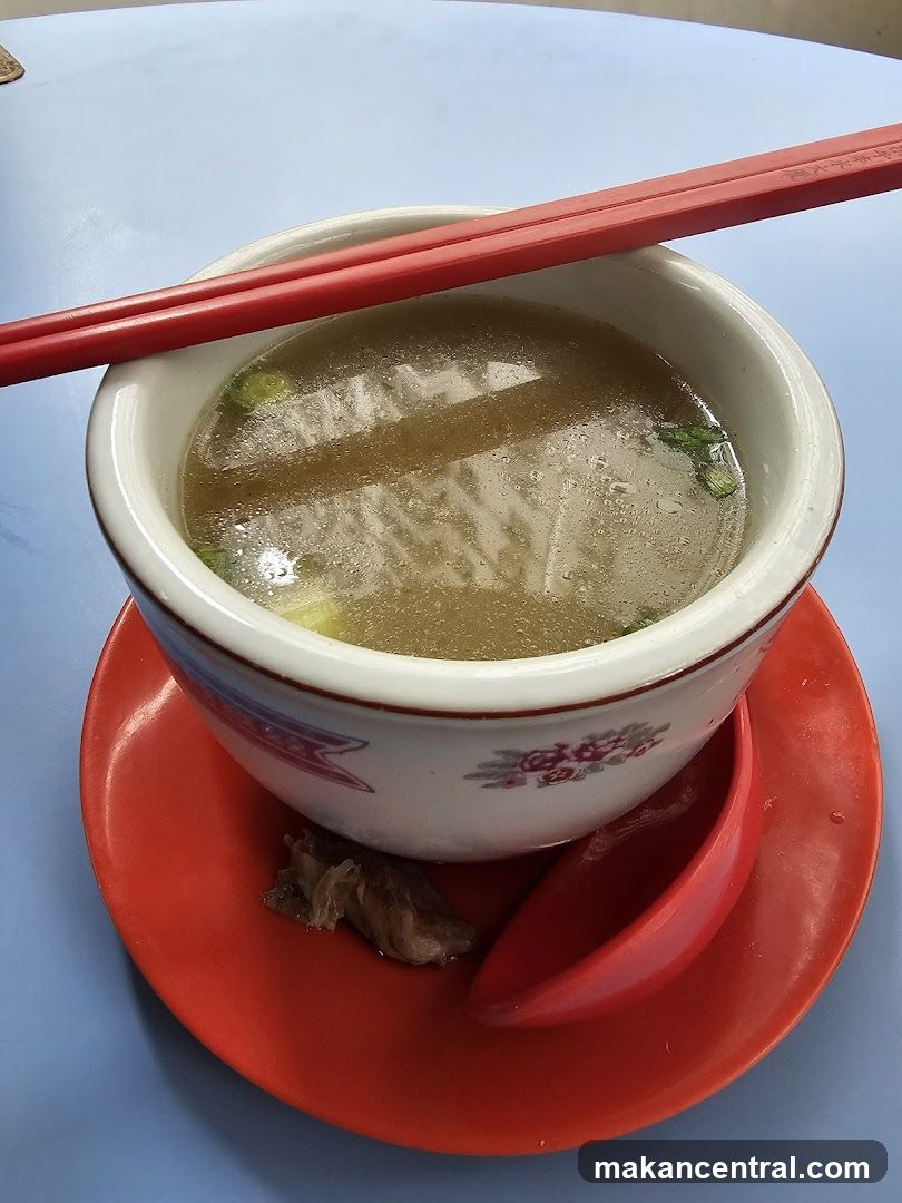 Bowl of Soup with Chopsticks and Spoon