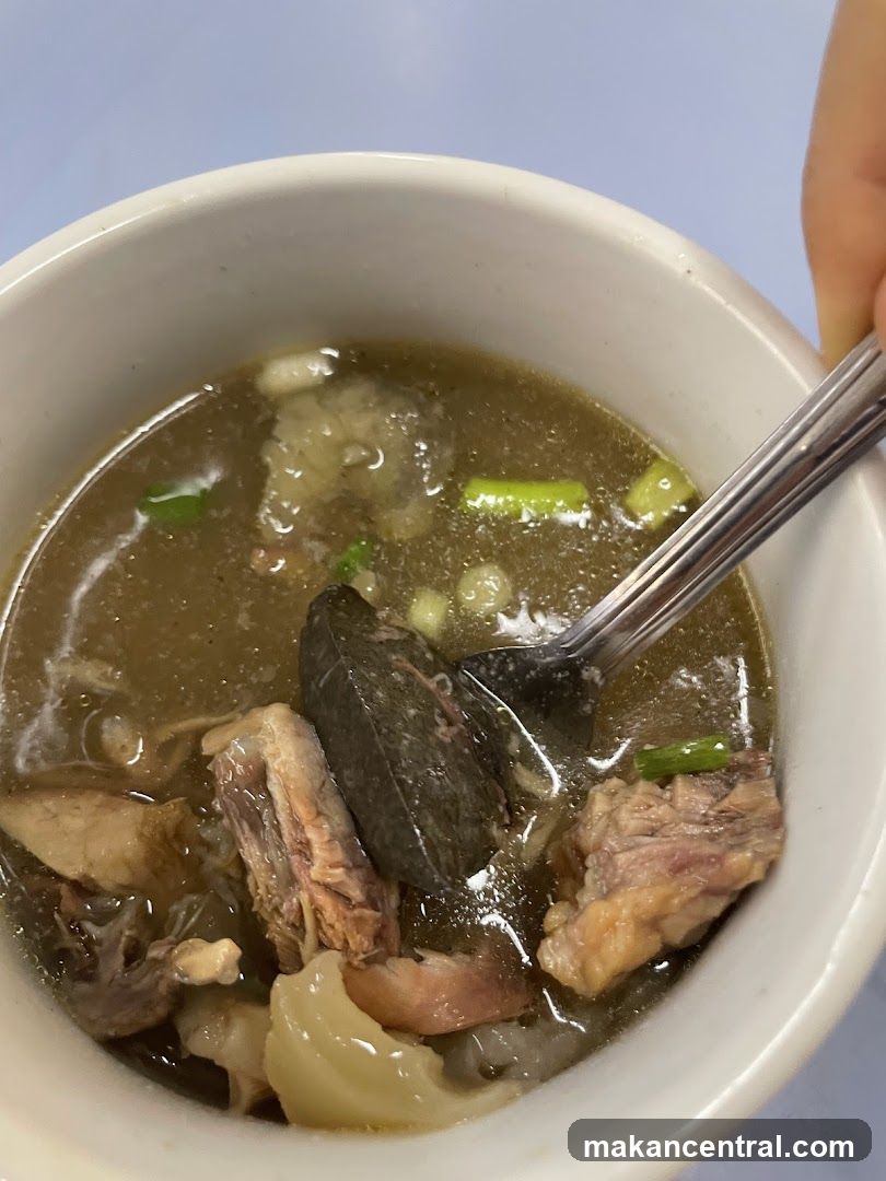 Bowl of Soup with Meat and Greens
