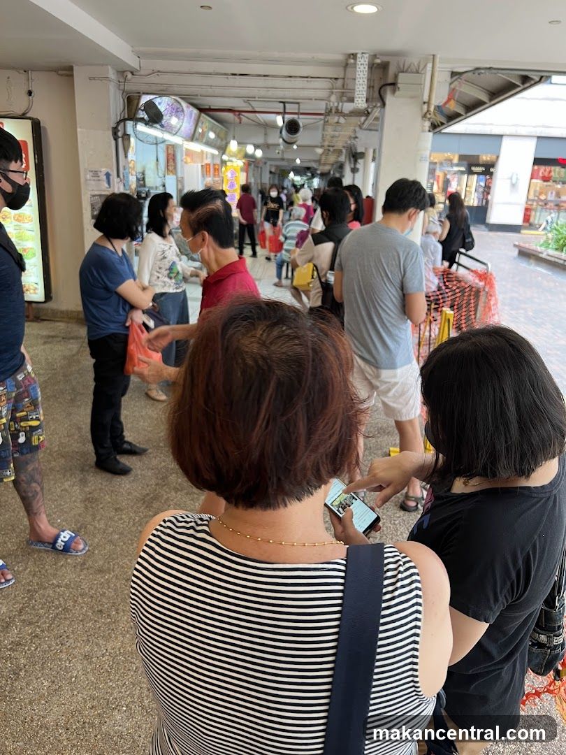 People queuing at an outdoor food court