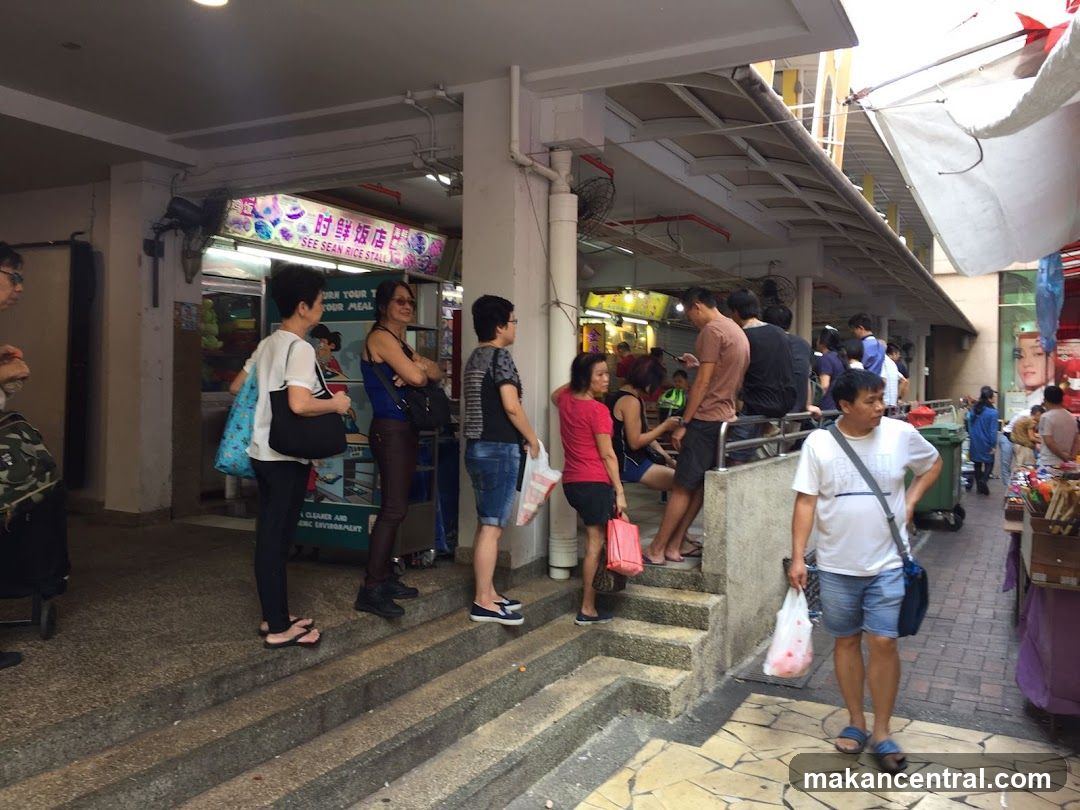 People queuing at a food stall