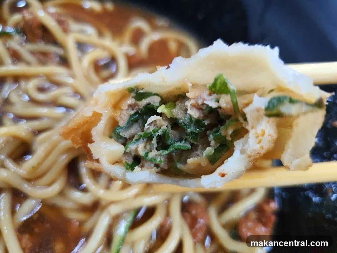 Close-up of a dumpling with noodles