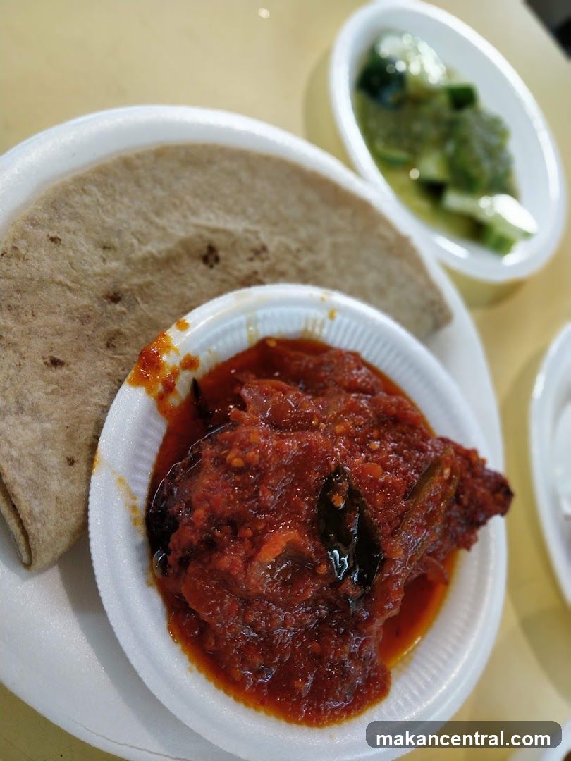 Spicy Chicken Dish with Flatbread and Cucumber Salad