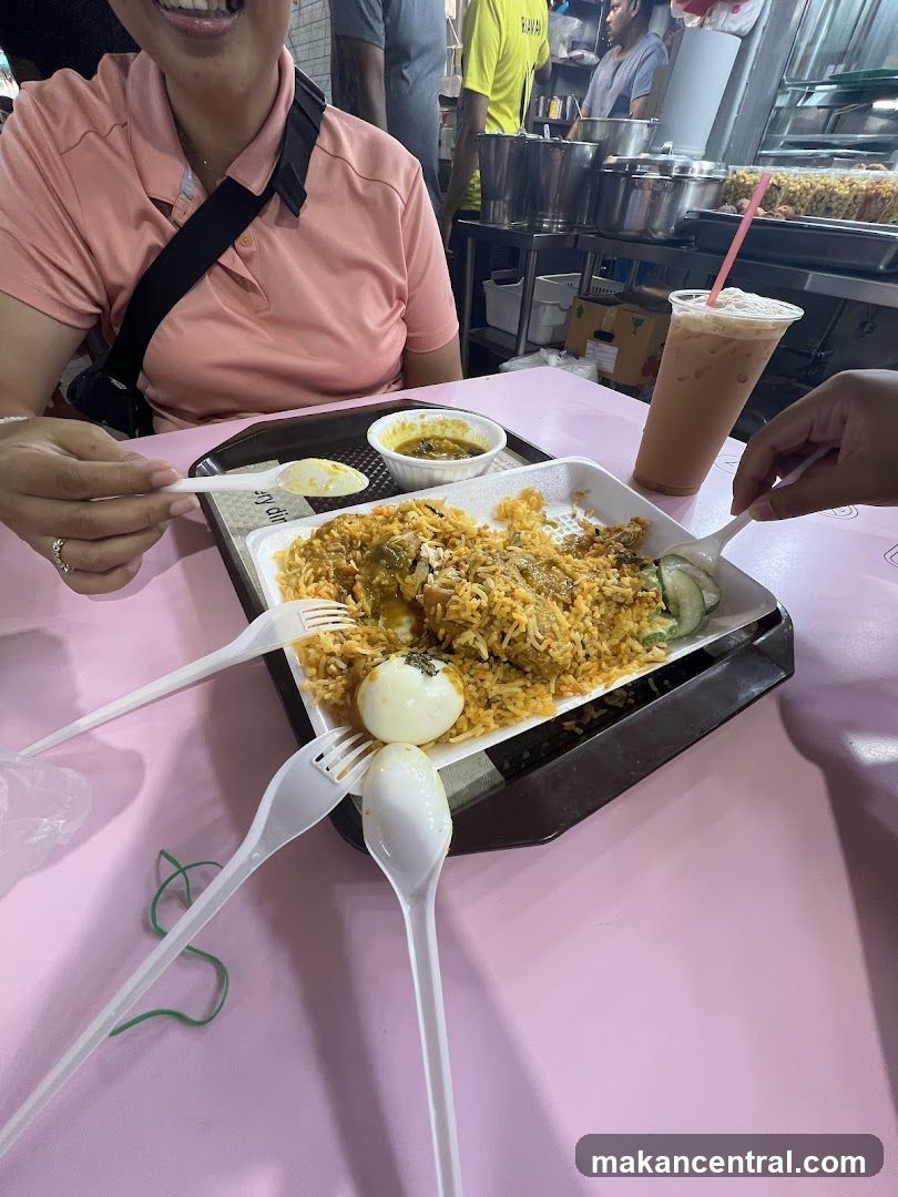 People eating biryani at a food stall