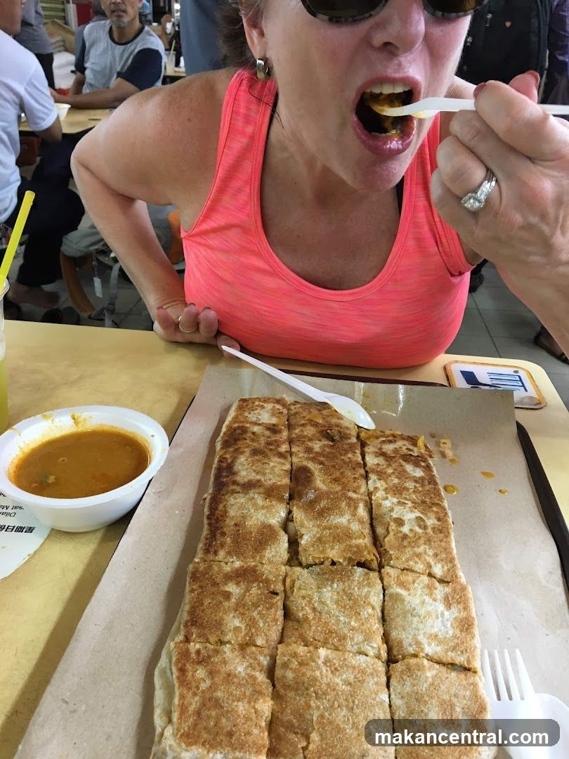 Woman eating murtabak