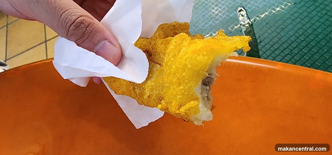 Hand holding a fried pastry