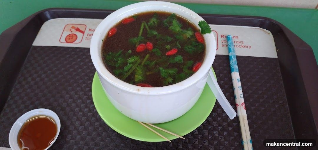 Bowl of Soup with Herbs and Berries