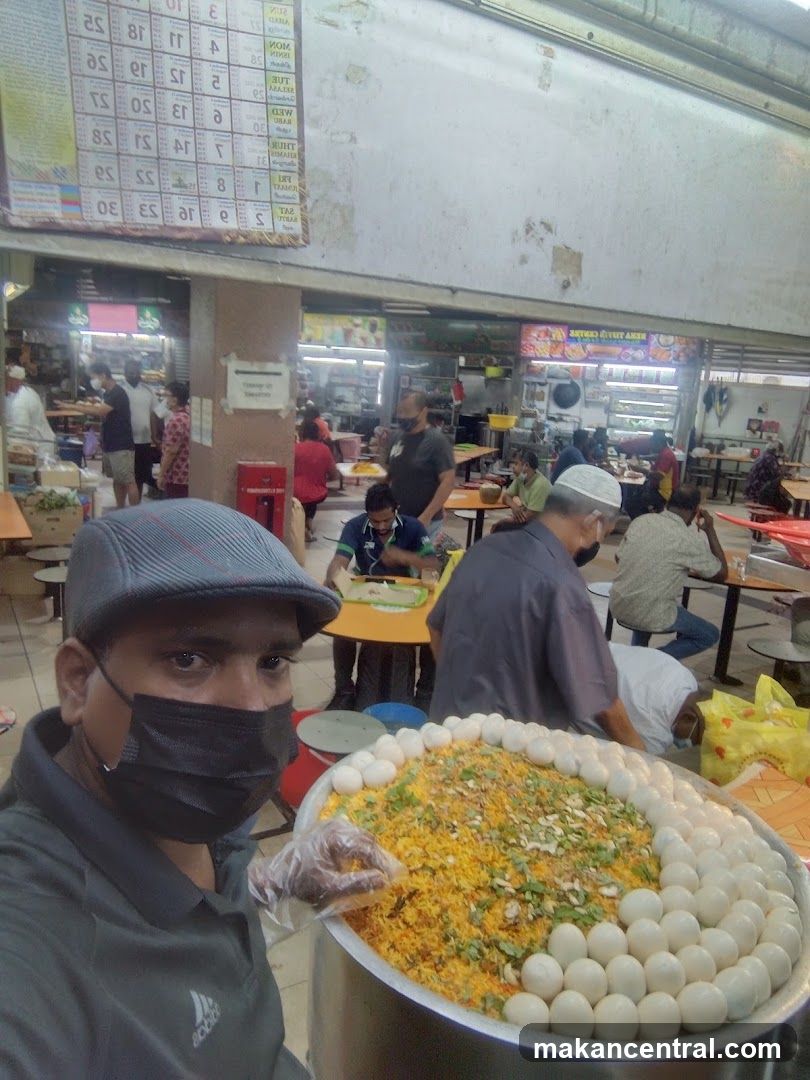 Man with a large dish of biryani