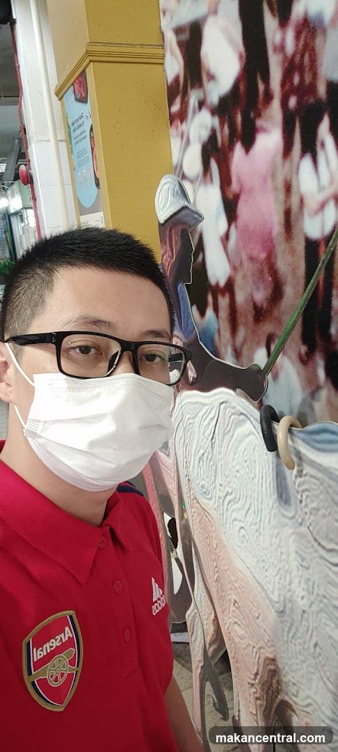 Man in Arsenal Shirt Posing with Artwork