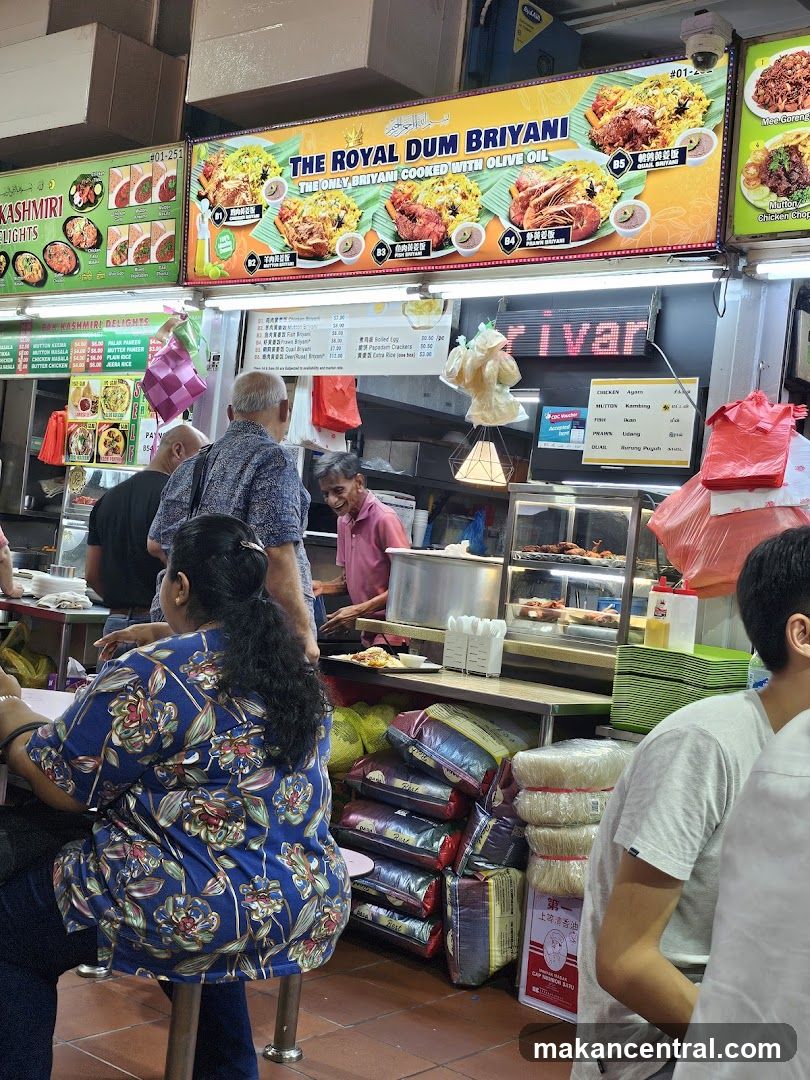 Food stall with signage and customers