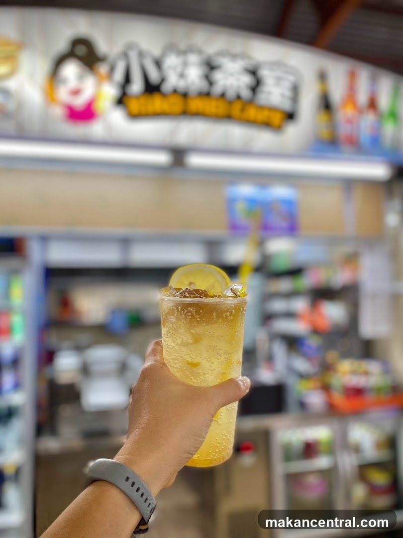 Hand holding a drink in front of a shop