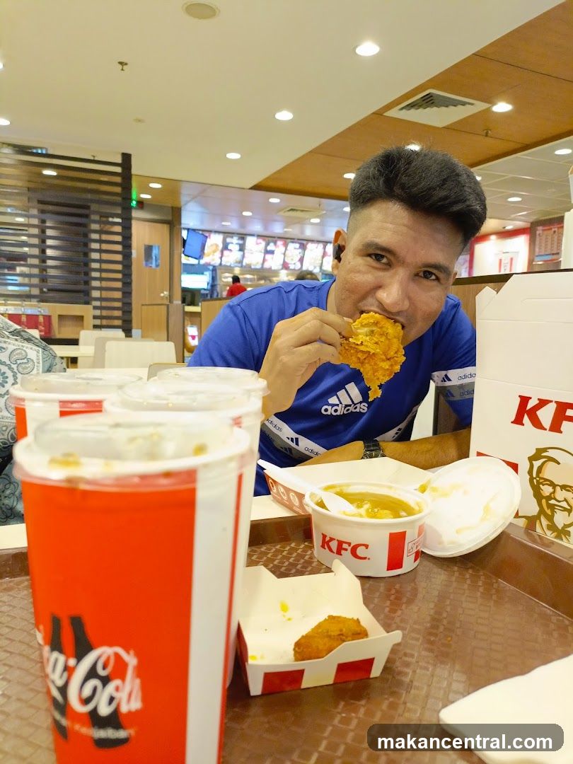 Man eating fried chicken at KFC