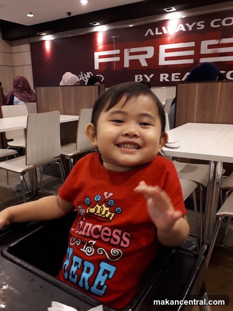 Child in high chair at restaurant