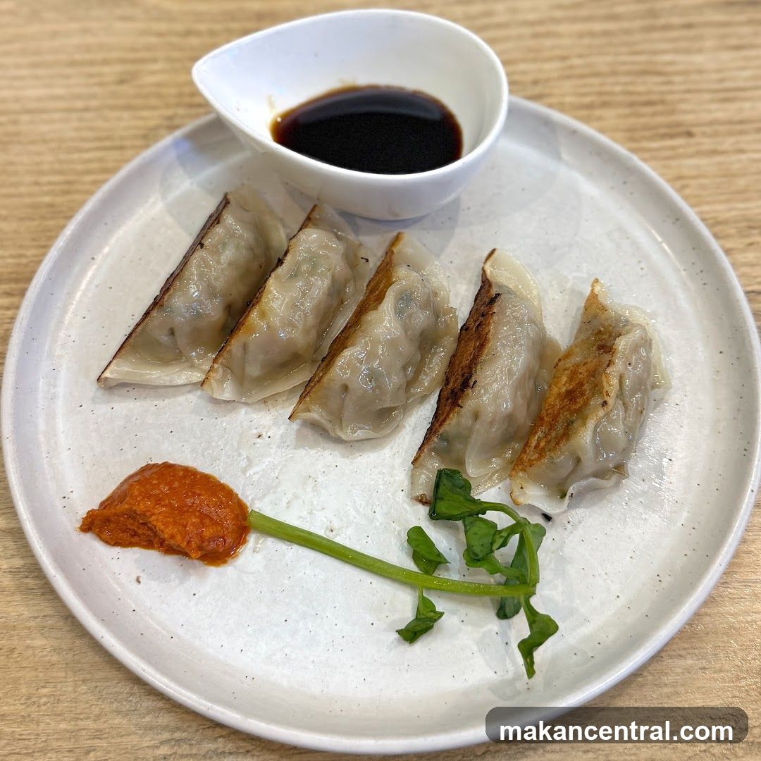 Pan-fried dumplings with dipping sauce