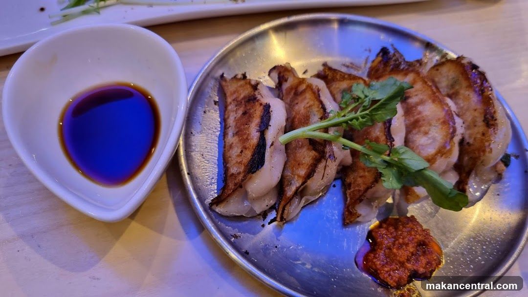Pan-fried dumplings with dipping sauce