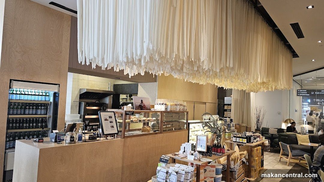 Interior of a cafe with a display of baked goods and beverages