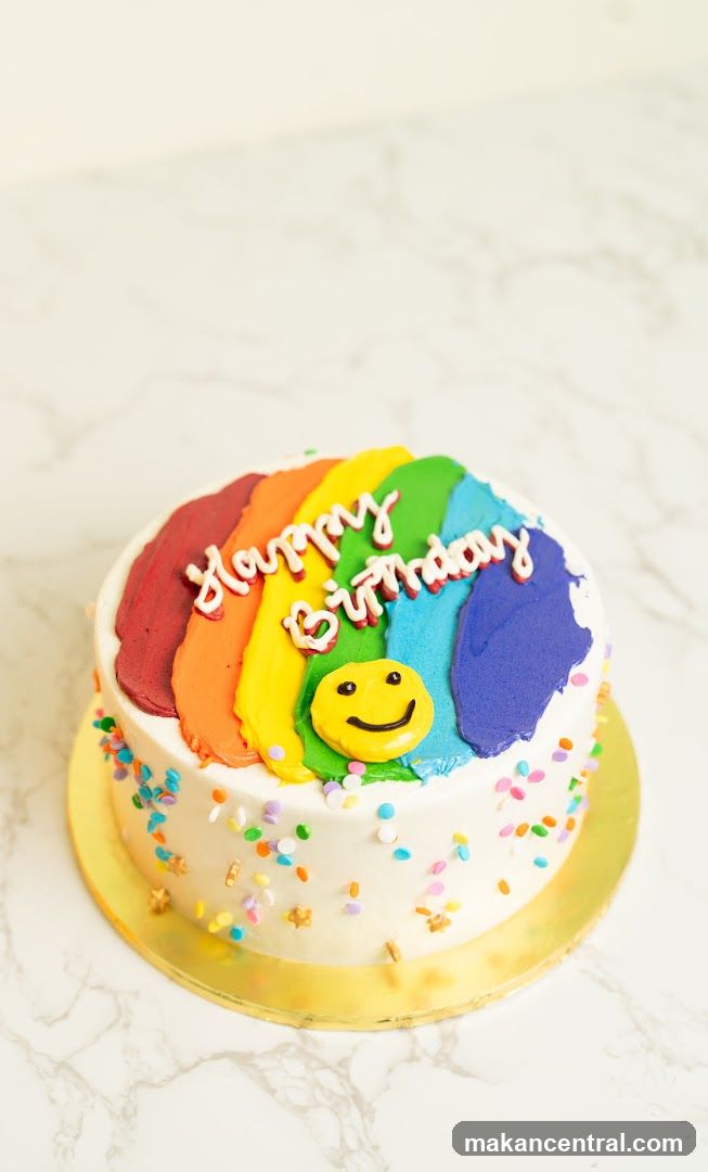 Birthday Cake with Rainbow Frosting and Smiley Face