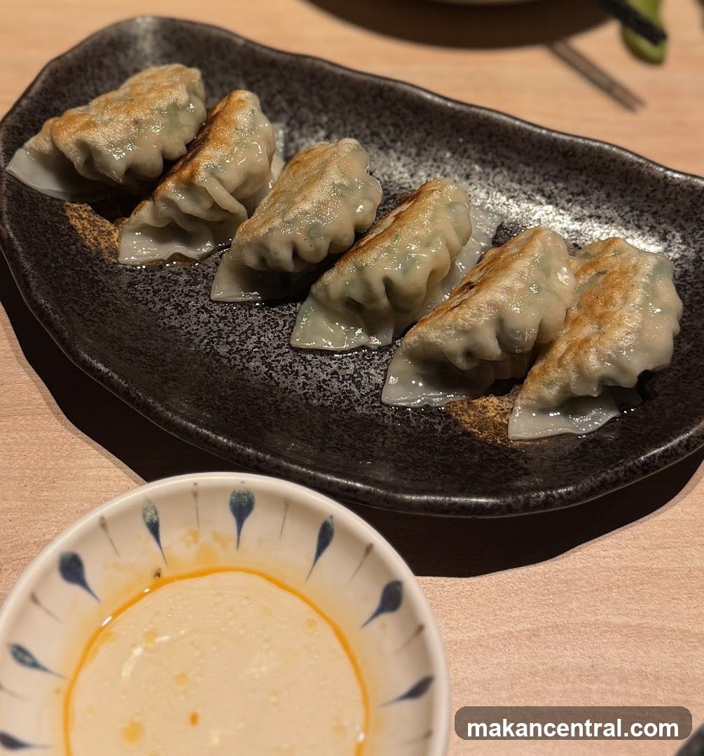 Pan-fried dumplings with dipping sauce