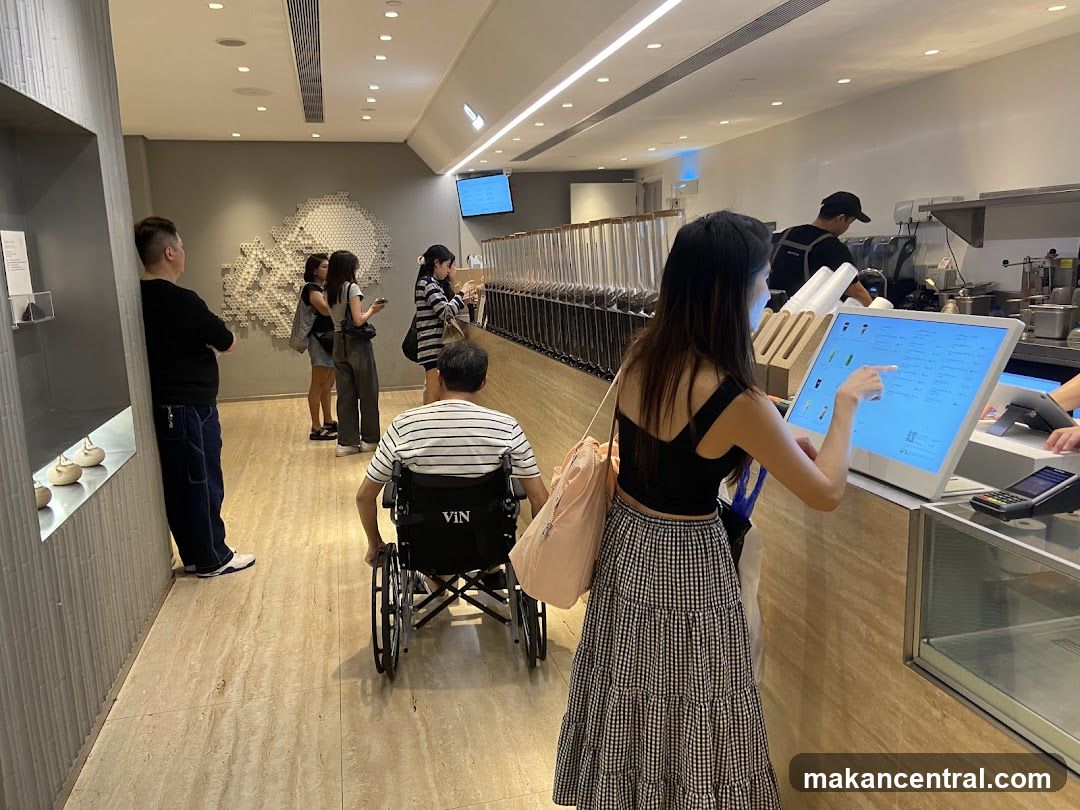 Customers ordering at a digital kiosk