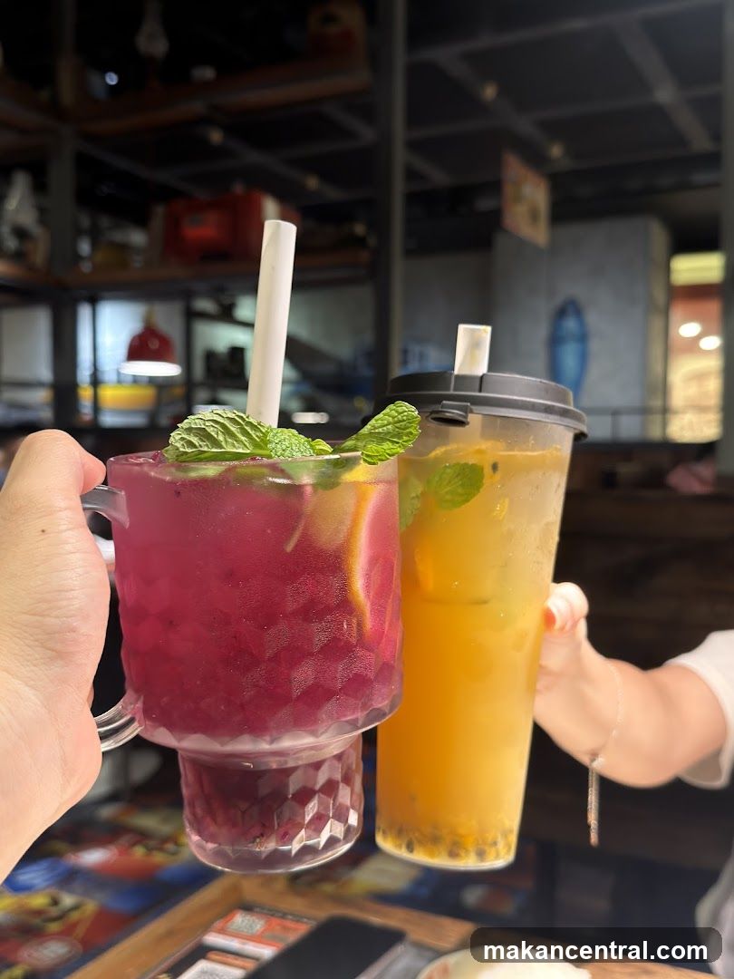 Two drinks being held up in a restaurant interior
