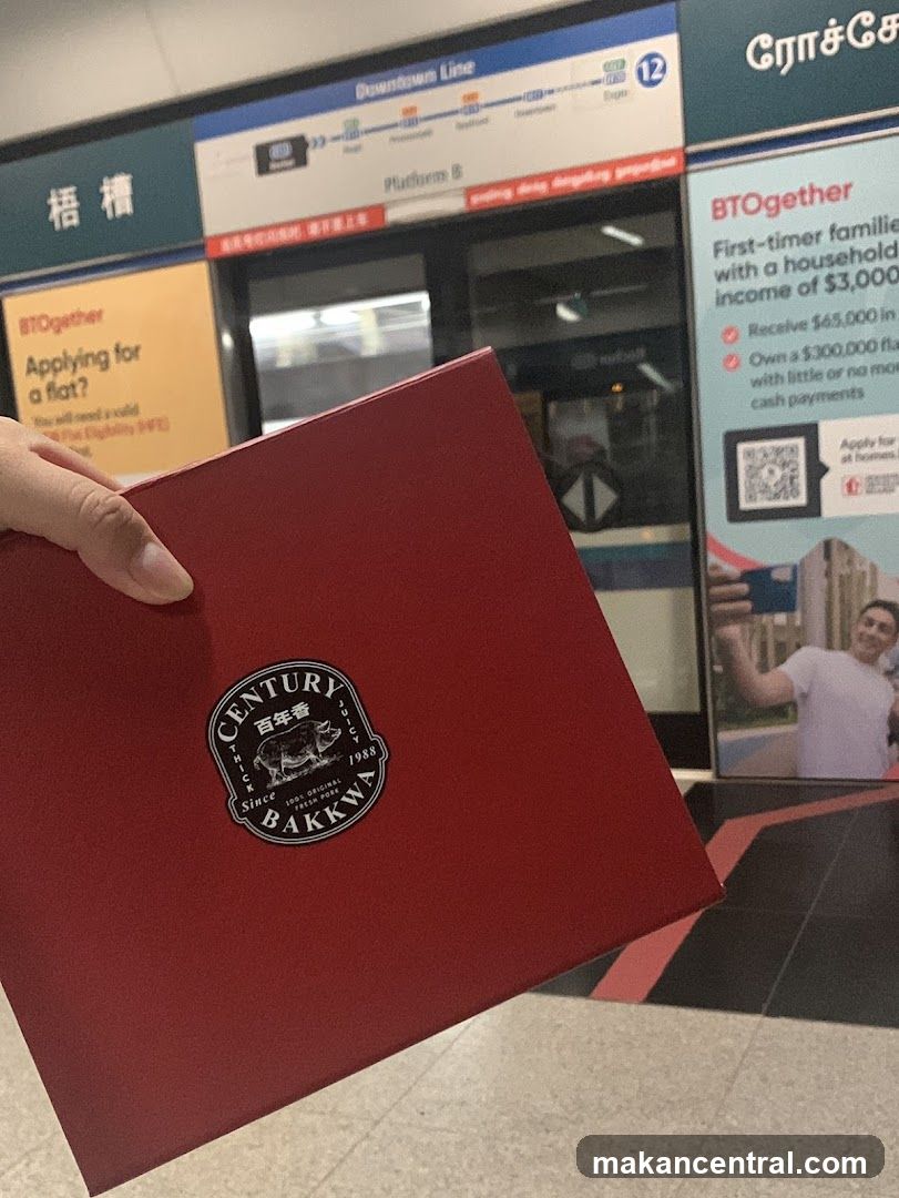 Hand holding red folder at train station