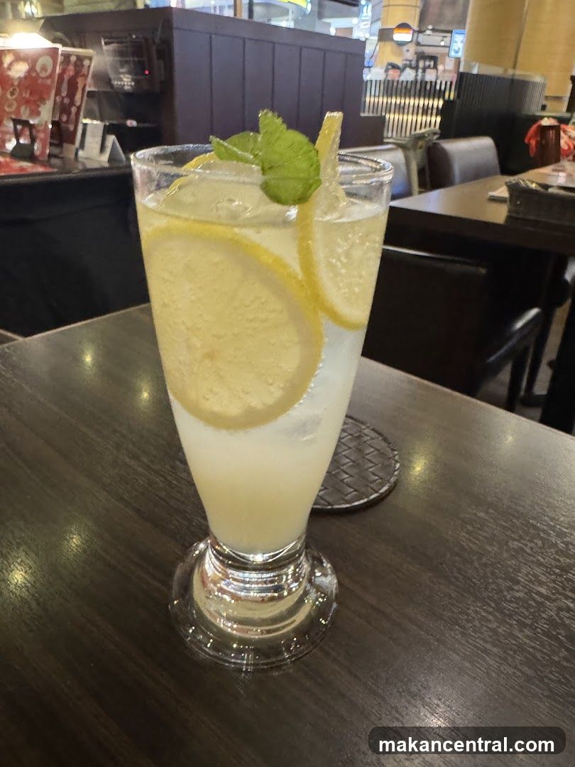Lemonade in a tall glass with garnish on wooden table
