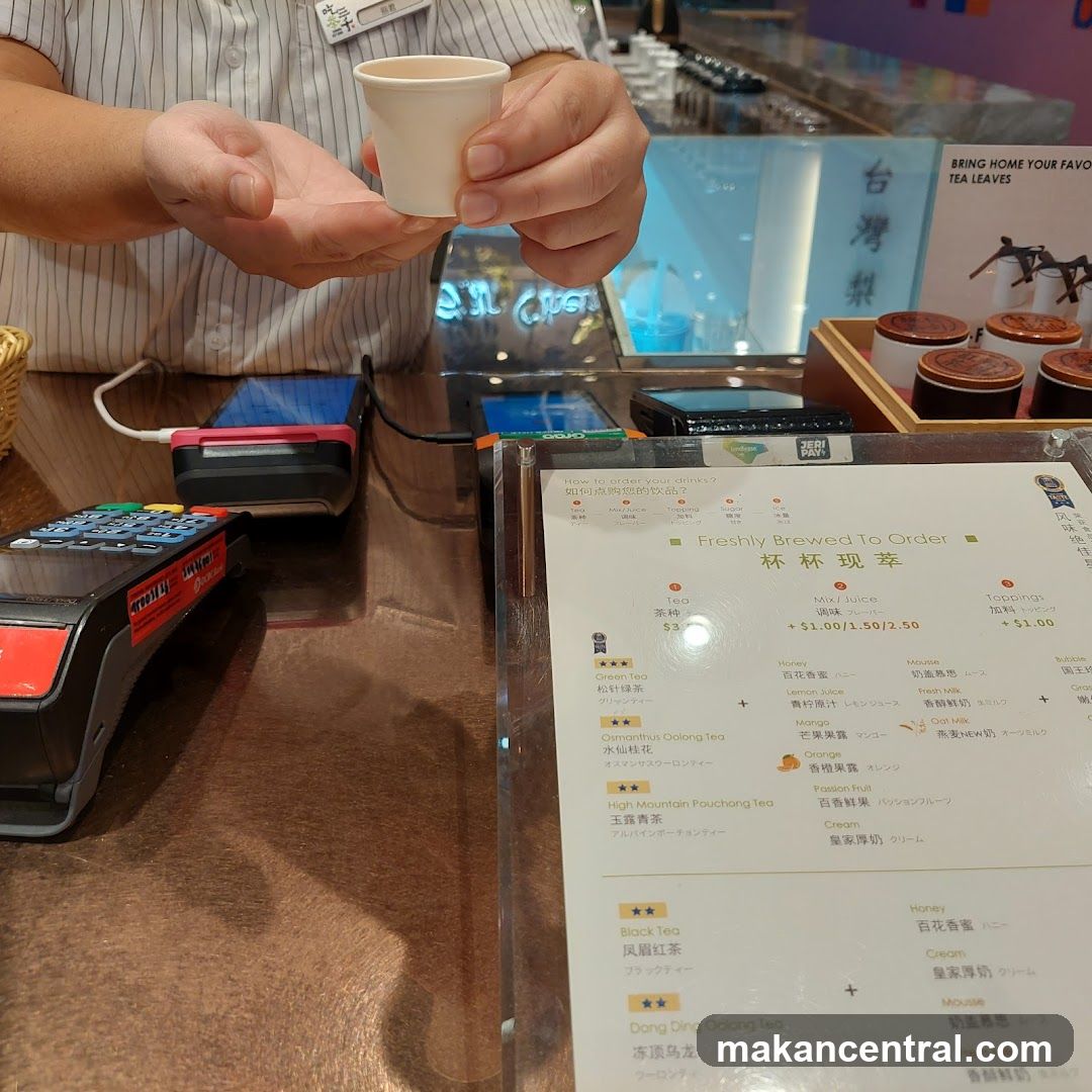 Staff serving drink at counter