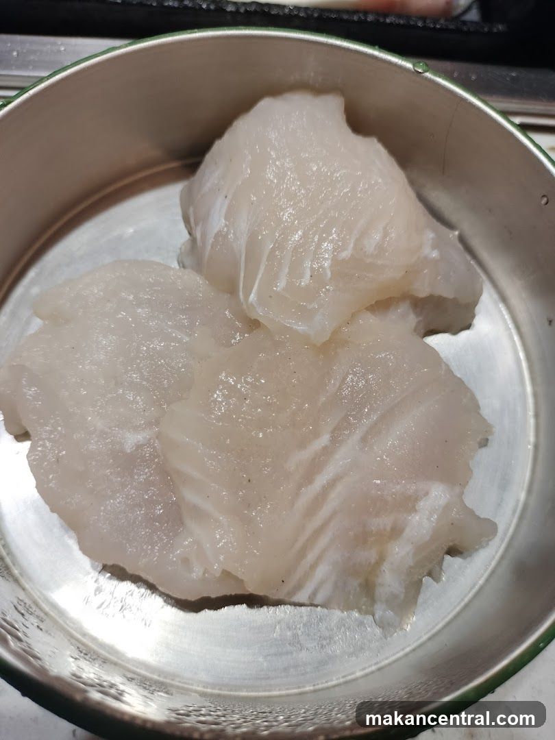 Raw Fish Fillets in Metal Bowl