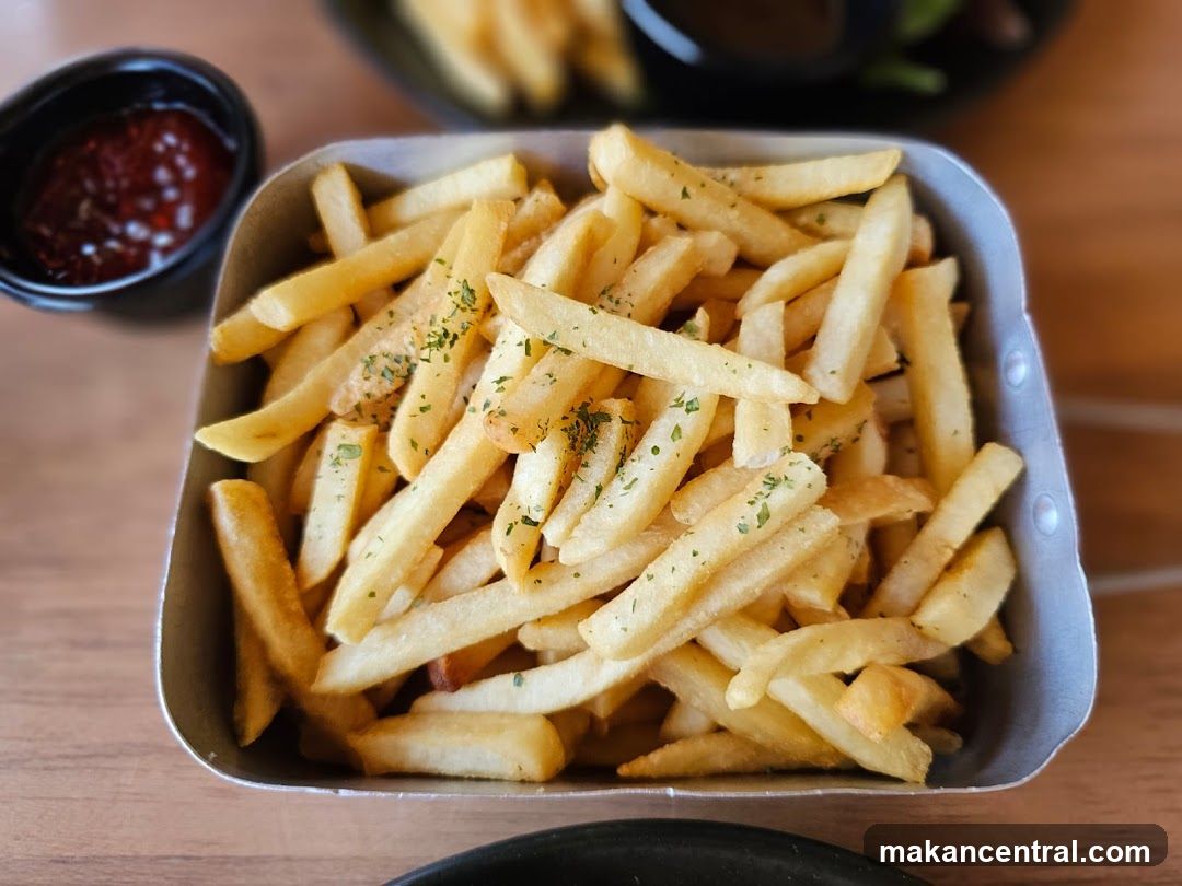 Fries with garnish and dipping sauce