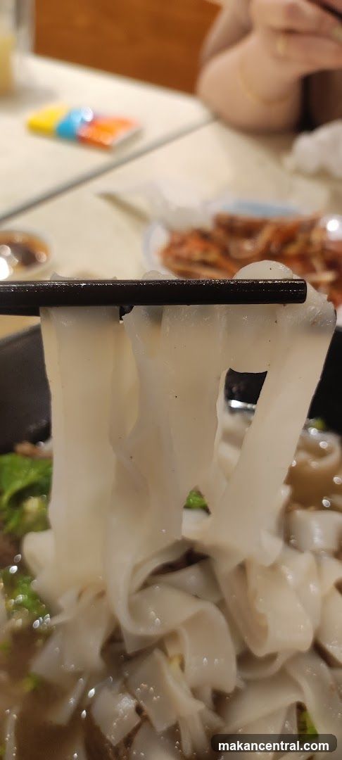 Close-up of noodles being lifted with chopsticks