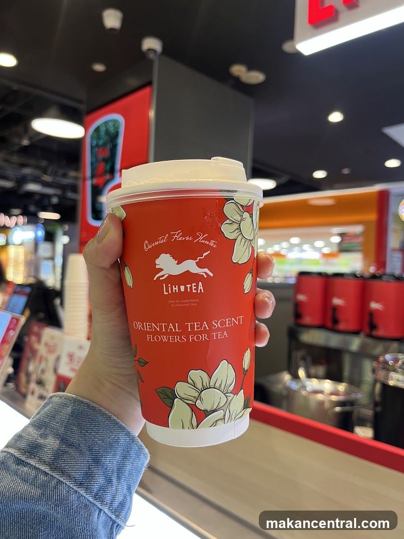 Hand holding Lihotea tea cup