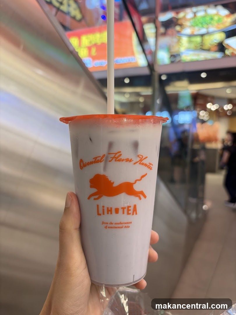 Hand holding LiHOTEA drink cup