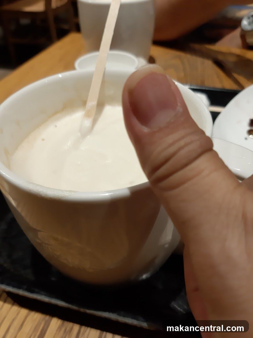 Close-up of beverage in cup with finger pointing