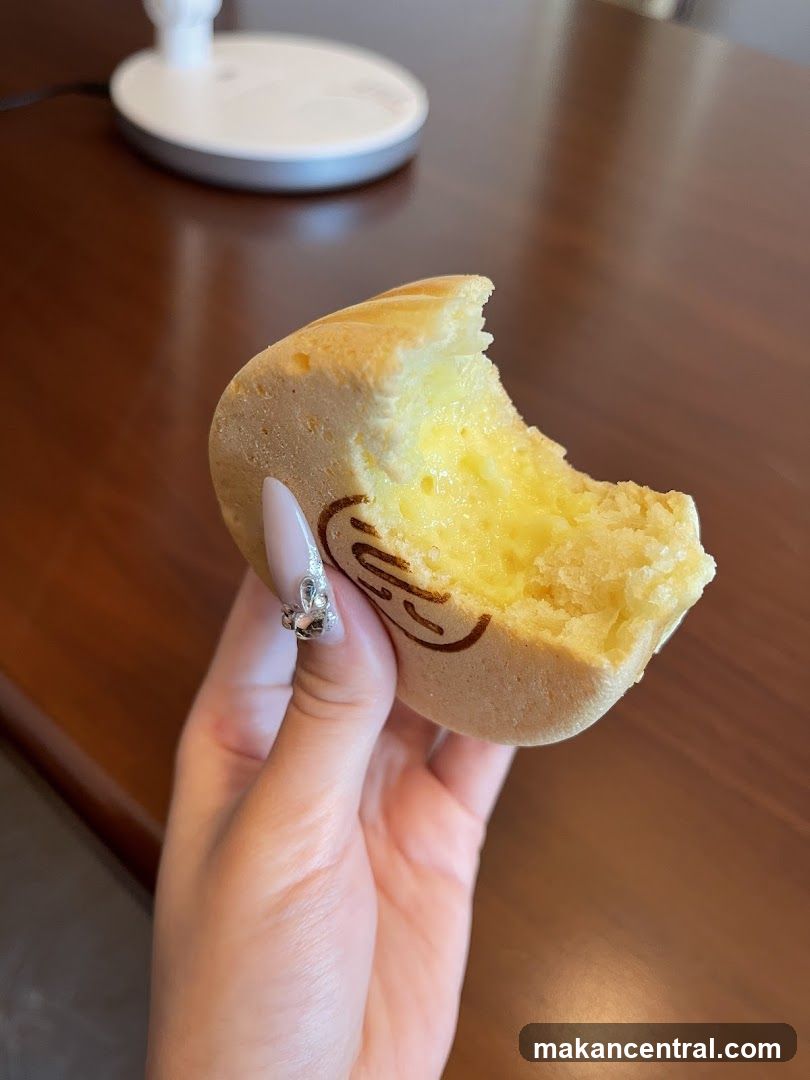 Hand holding a partially eaten pastry