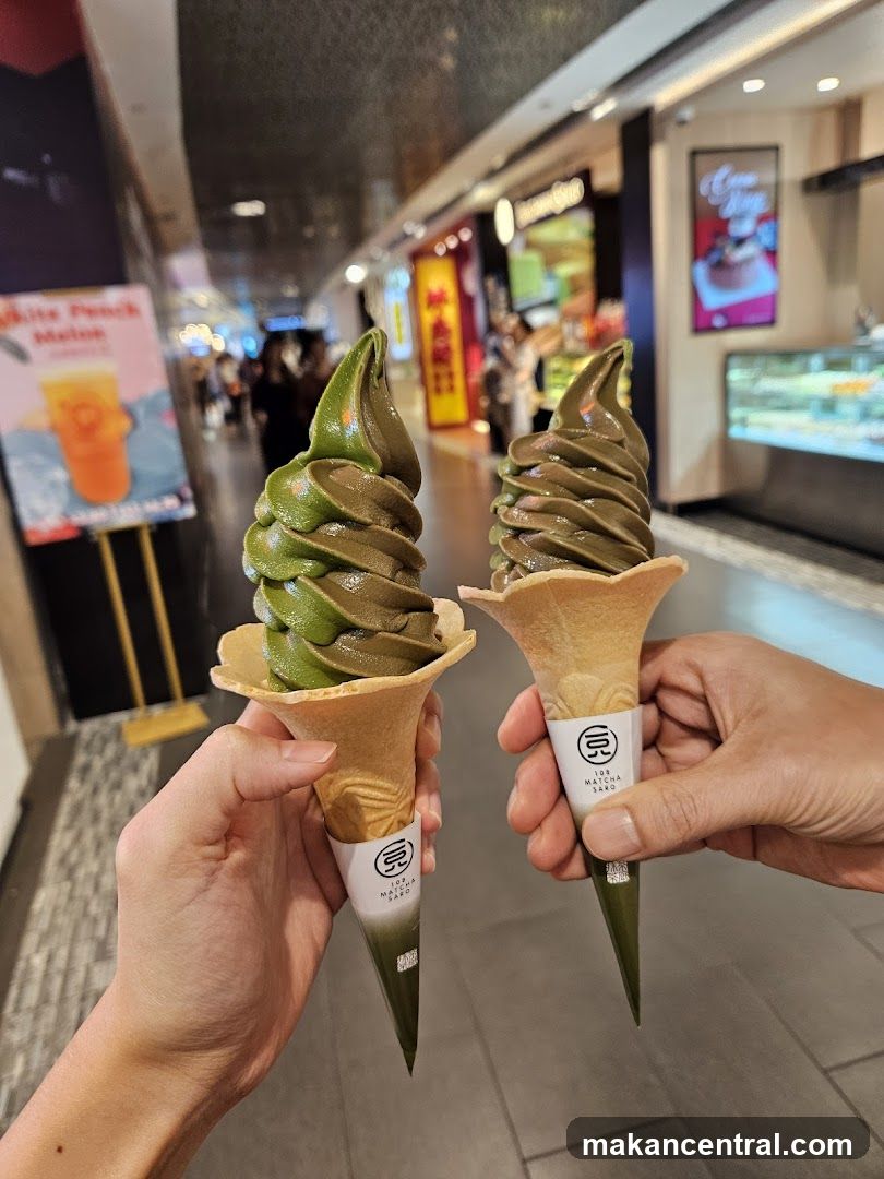 Two hands holding matcha ice cream cones