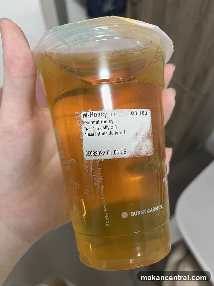 Hand holding a drink cup