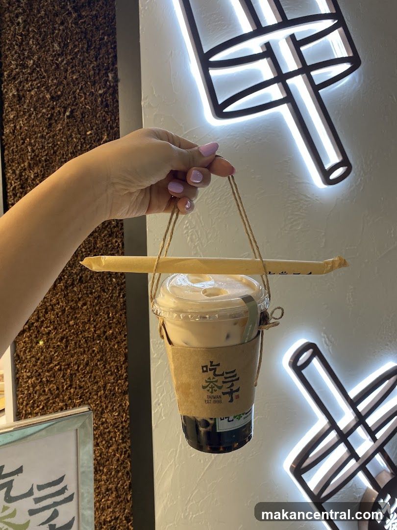 Hand holding iced tea drink