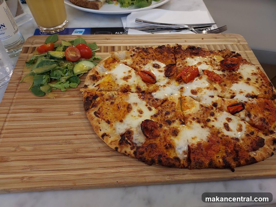 Pizza and Salad on Wooden Board