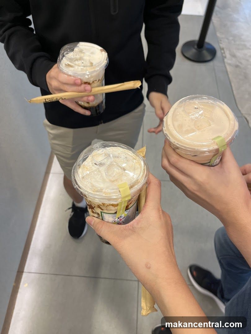 People holding iced beverages