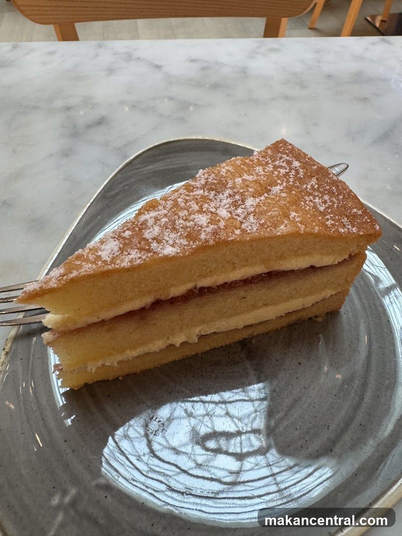 Slice of layered cake on ceramic plate