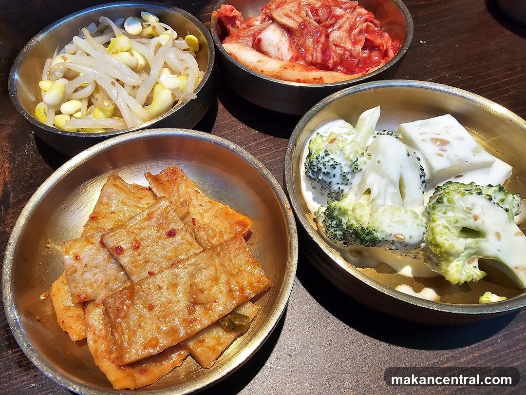 Korean side dishes served in metal bowls