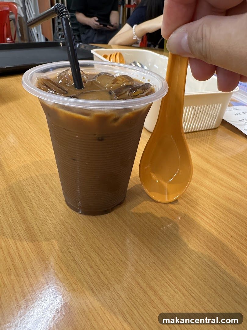 Iced coffee drink with spoon on wooden table