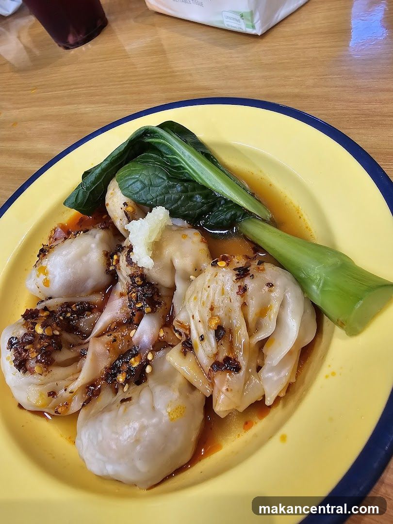 Dumplings with greens on a yellow plate