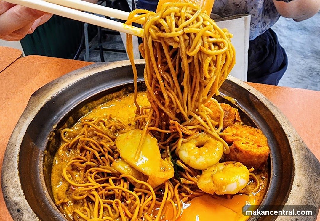 Noodles being lifted with chopsticks
